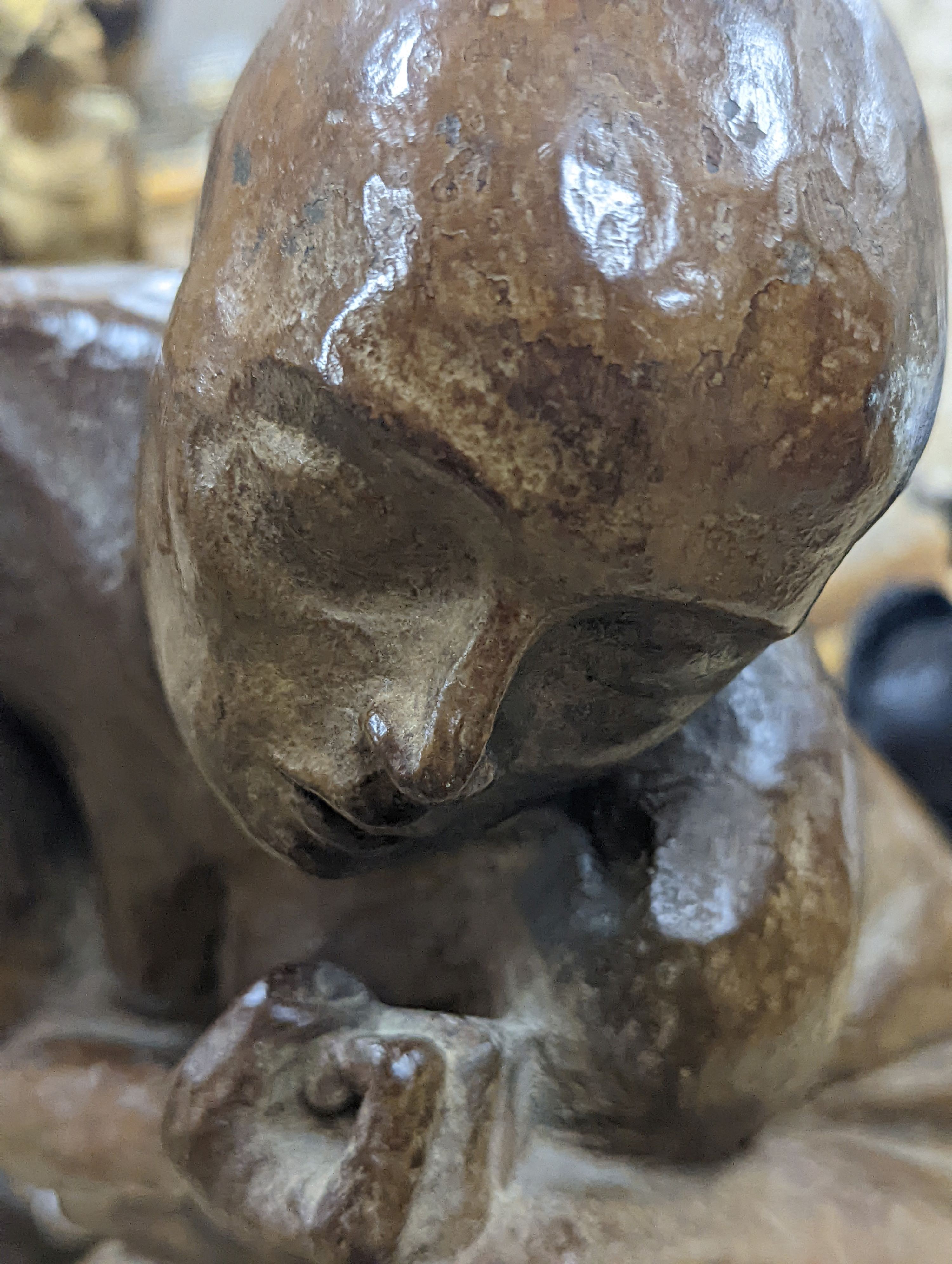 A contemporary bronze of a lady crouching with a thoughtful expression, unsigned - 31cm high